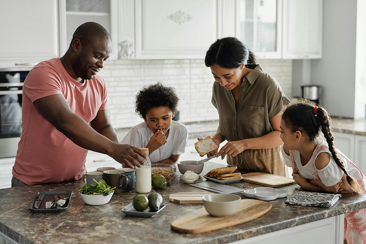 family making lunch together